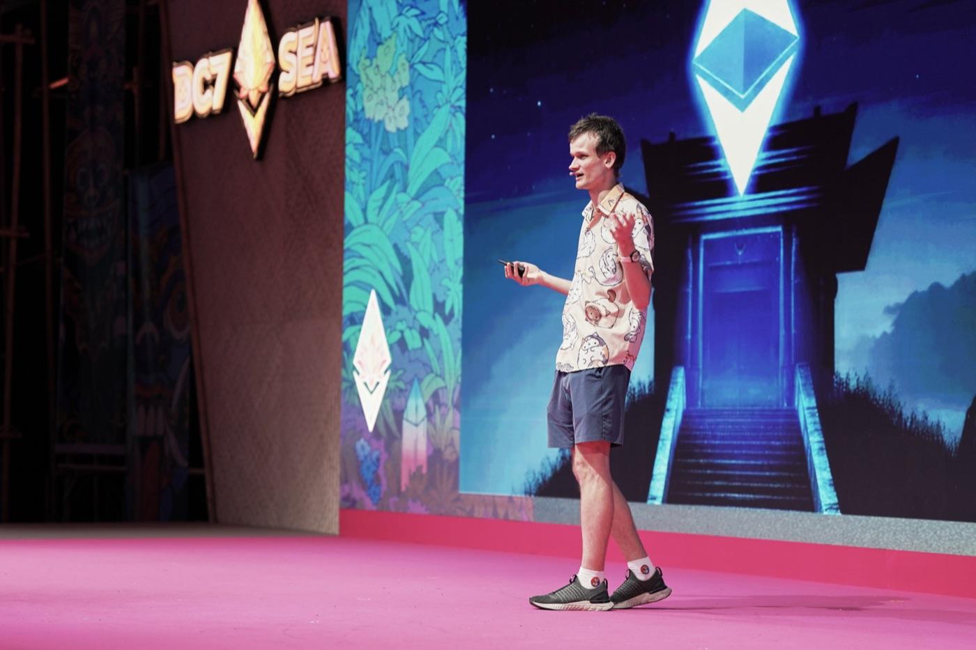 A speaker presenting on stage at Devcon