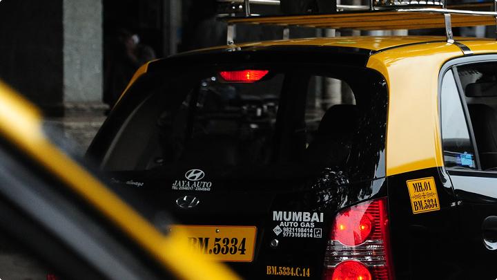 A black-and-yellow Mumbai taxi